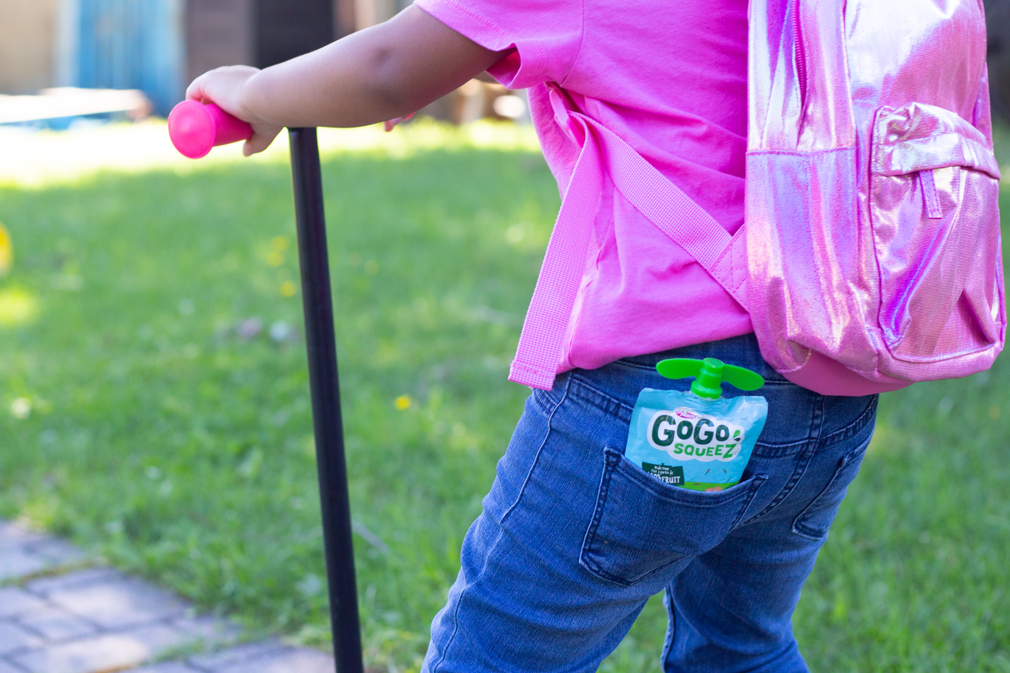 toddler with fruit pouch in her pocket