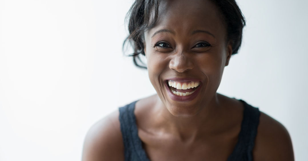 Black women smiling into the camera