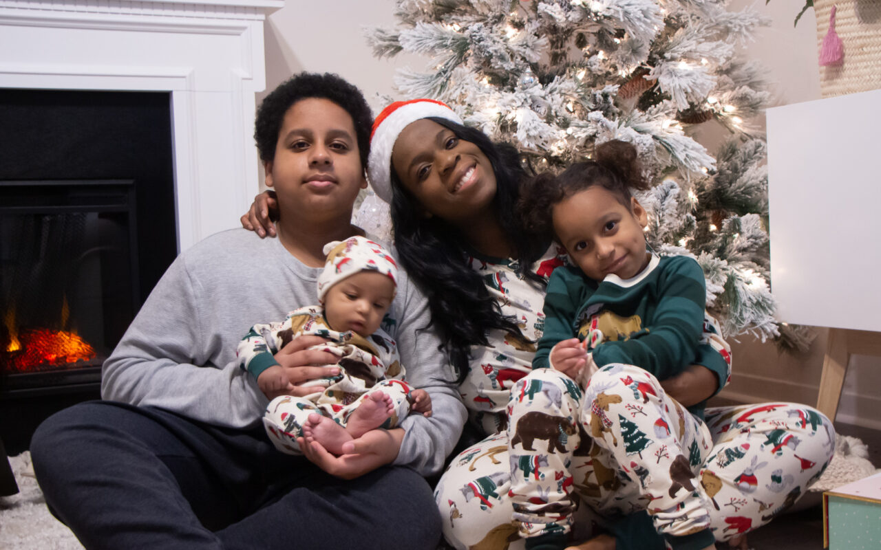 Black mom and kids wearing matching pjs