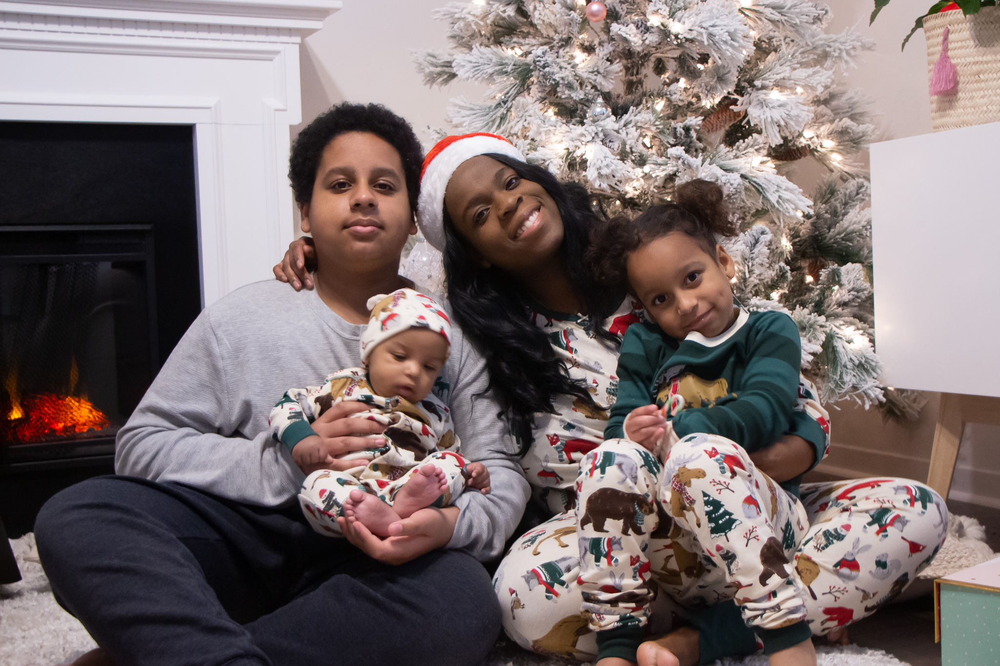 Black mom and kids wearing matching pjs