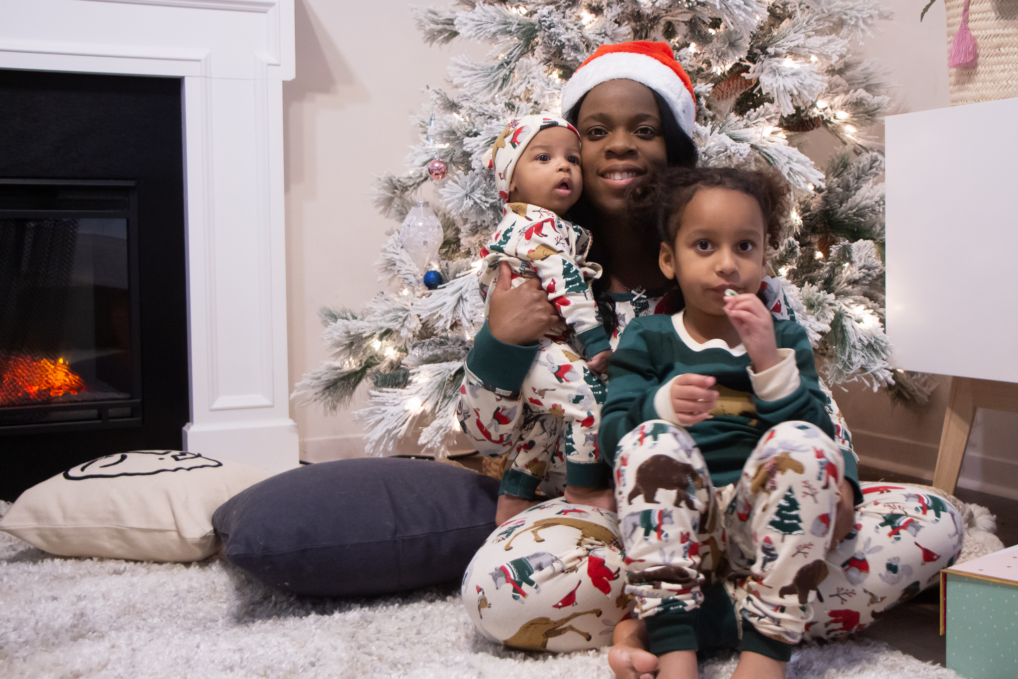 Black mom and kids wearing matching pjs