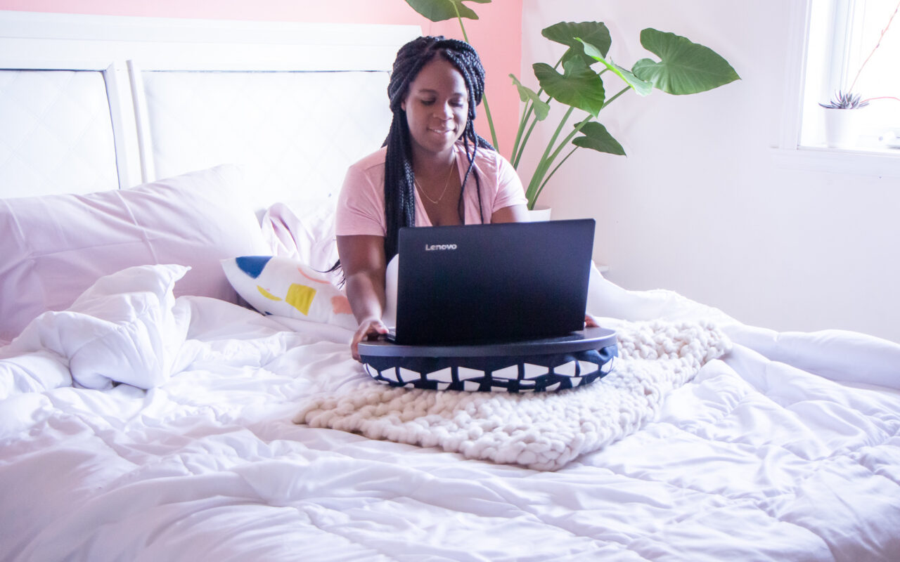 black mom on a computer Bossing Your Life as a Working Mother in 2021 & Beyond